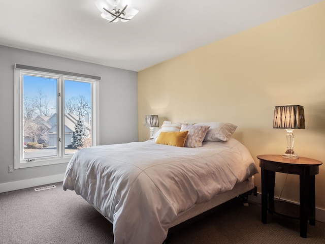 carpeted bedroom featuring baseboards and visible vents