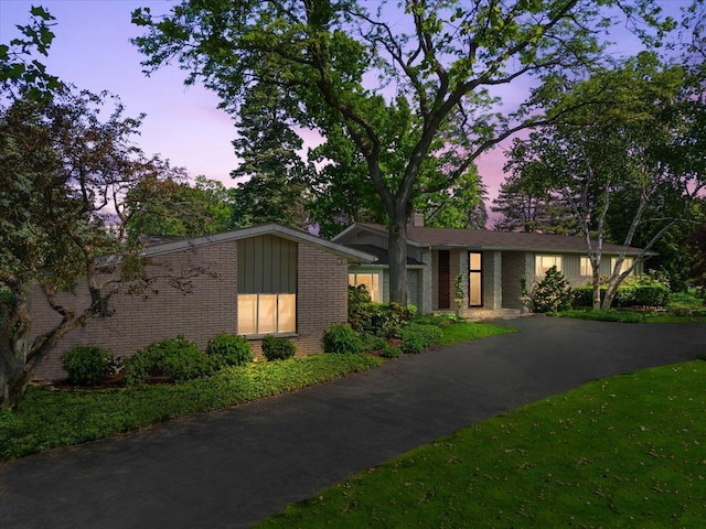 mid-century home with brick siding