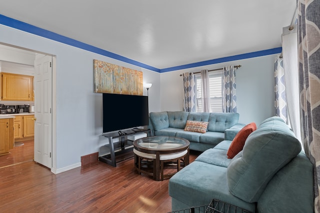 living room featuring baseboards and wood finished floors