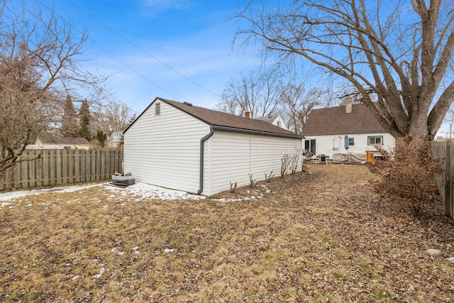 exterior space with an outbuilding and a fenced backyard