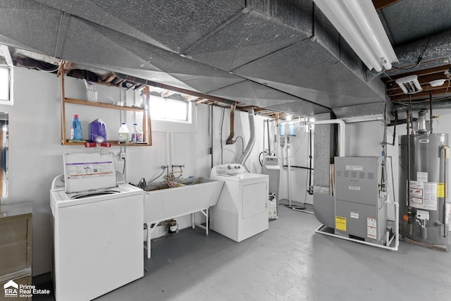 basement featuring washer and clothes dryer, gas water heater, a sink, and heating unit