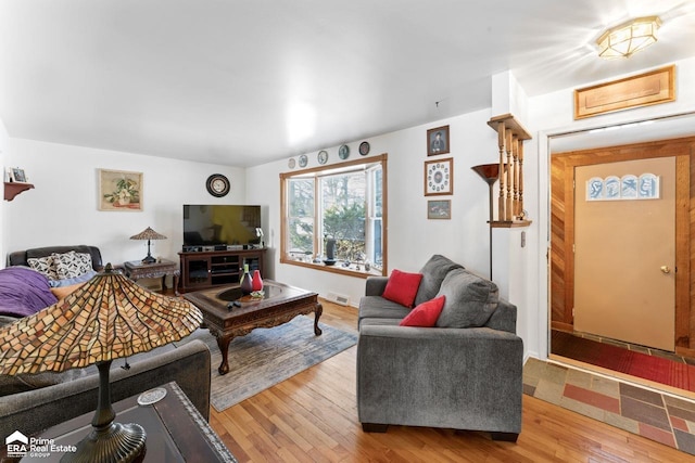 living room featuring wood finished floors and visible vents