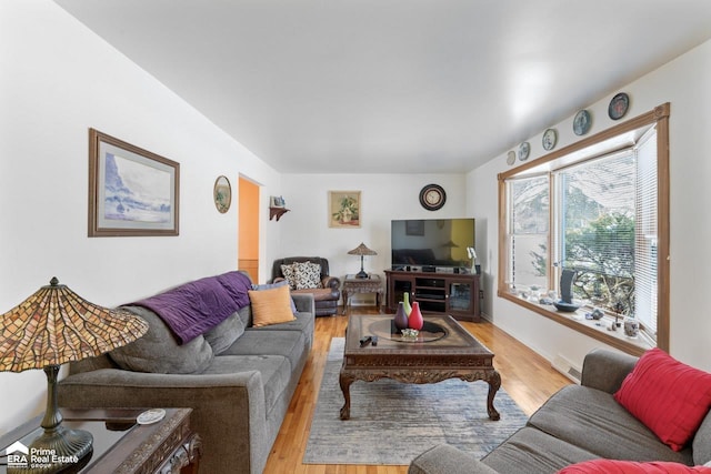 living room featuring light wood finished floors and visible vents