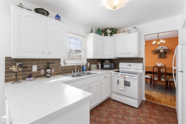 kitchen featuring under cabinet range hood, white appliances, a sink, white cabinetry, and light countertops