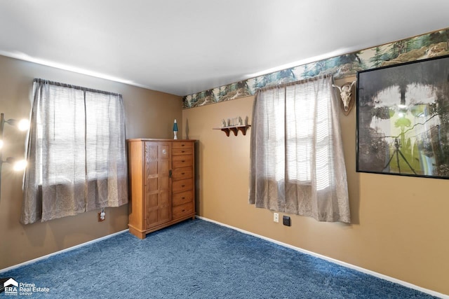 unfurnished bedroom with carpet flooring and baseboards