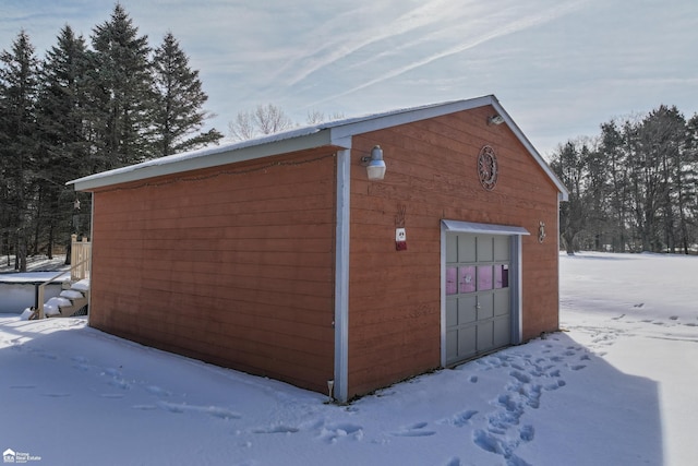 snow covered structure with an outdoor structure