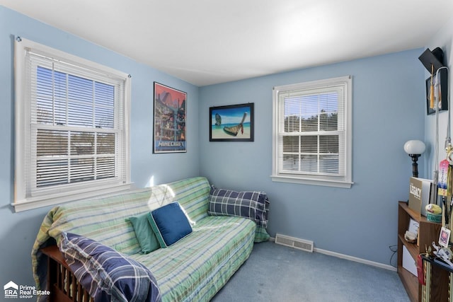 sitting room featuring a wealth of natural light, carpet, visible vents, and baseboards