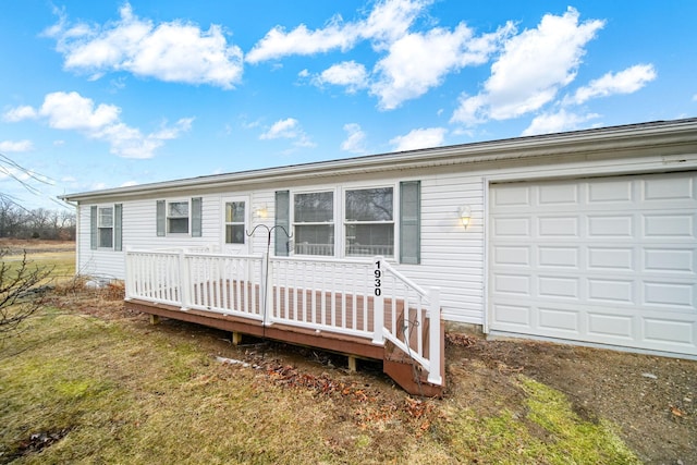 single story home with a front yard and an attached garage