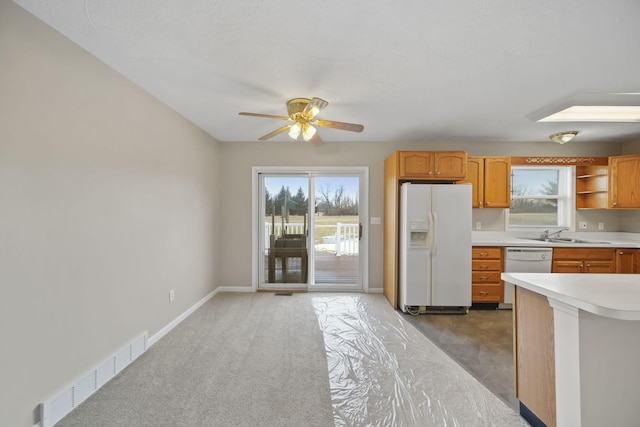 kitchen with open shelves, light countertops, visible vents, white appliances, and baseboards