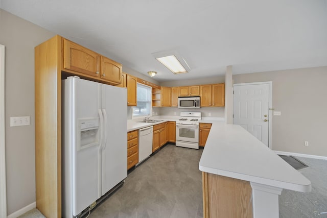 kitchen with white appliances, baseboards, light countertops, and a sink