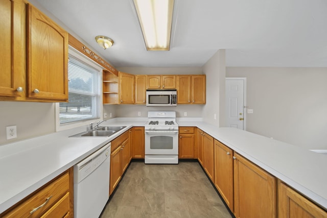 kitchen with open shelves, light countertops, a sink, white appliances, and a peninsula