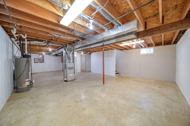 basement with gas water heater, electric panel, and heating unit