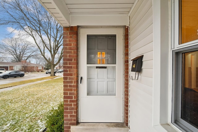 entrance to property with brick siding