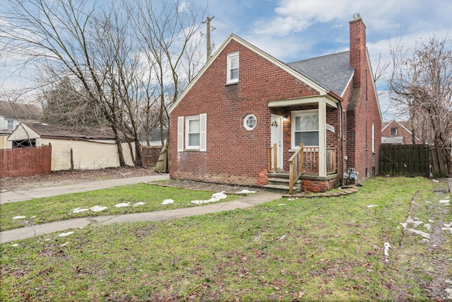 bungalow with brick siding, fence, and a chimney