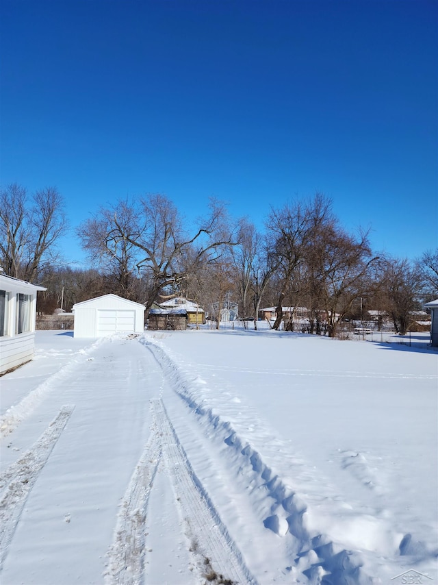 snowy yard featuring an outdoor structure