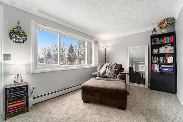 living area featuring carpet, a baseboard radiator, and a textured ceiling