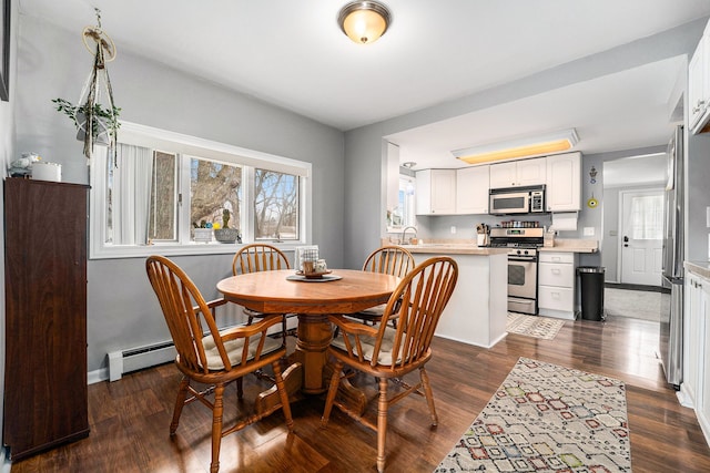 dining room featuring dark wood-type flooring and baseboards