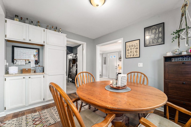 dining area with dark wood-type flooring