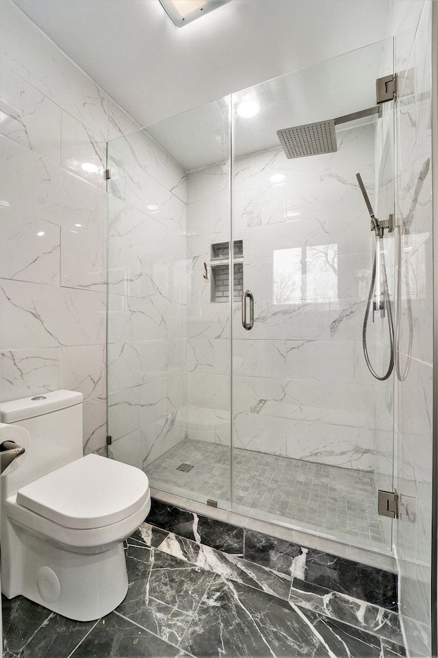 full bathroom with a marble finish shower, marble finish floor, and toilet