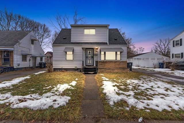 view of front of home featuring cooling unit and roof with shingles