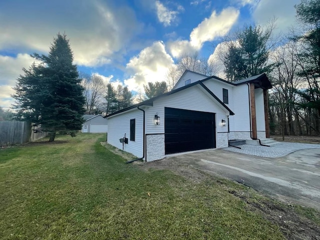 garage featuring driveway and fence