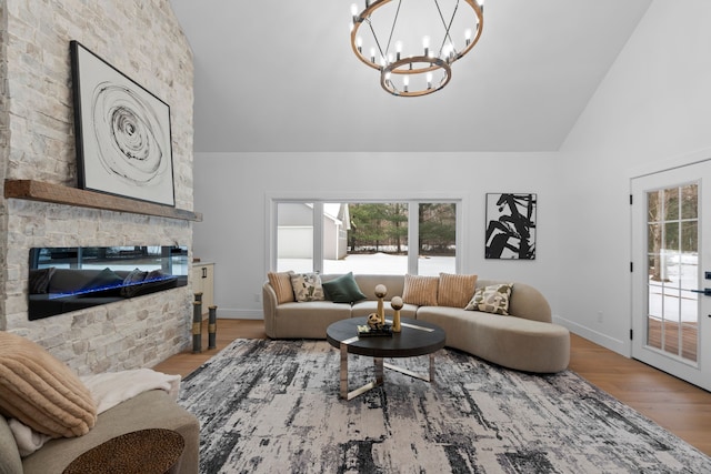 living room with a fireplace, wood finished floors, a wealth of natural light, and baseboards