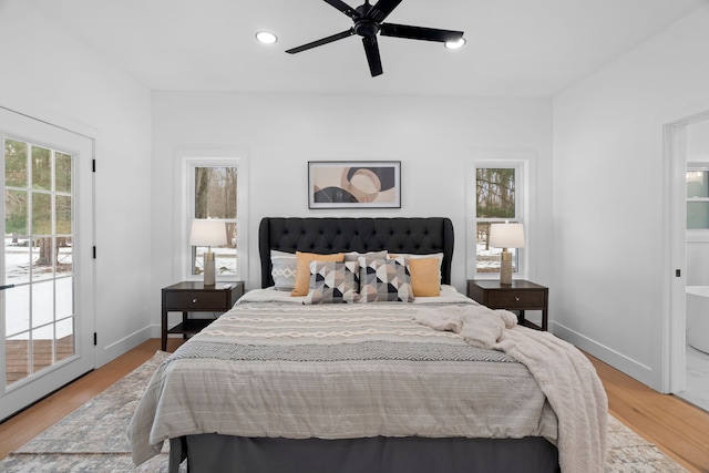 bedroom featuring access to outside, baseboards, wood finished floors, and recessed lighting