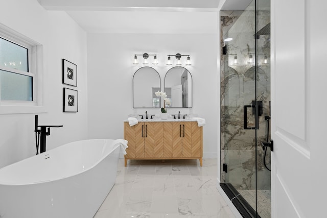 bathroom with a sink, a freestanding bath, marble finish floor, a marble finish shower, and double vanity