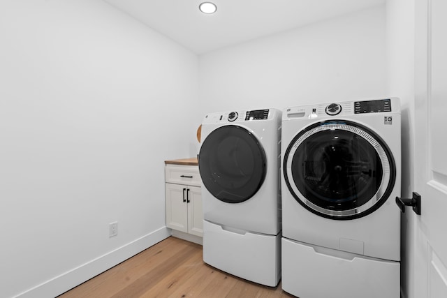 laundry area featuring recessed lighting, cabinet space, light wood-style flooring, separate washer and dryer, and baseboards