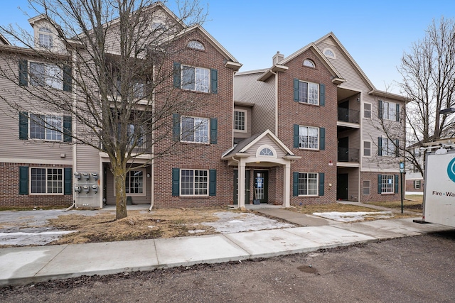 townhome / multi-family property with brick siding