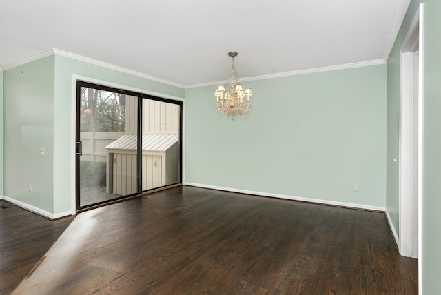 unfurnished dining area featuring baseboards, ornamental molding, wood finished floors, and an inviting chandelier