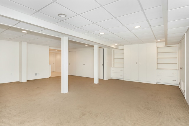 finished basement featuring built in shelves, carpet flooring, and recessed lighting