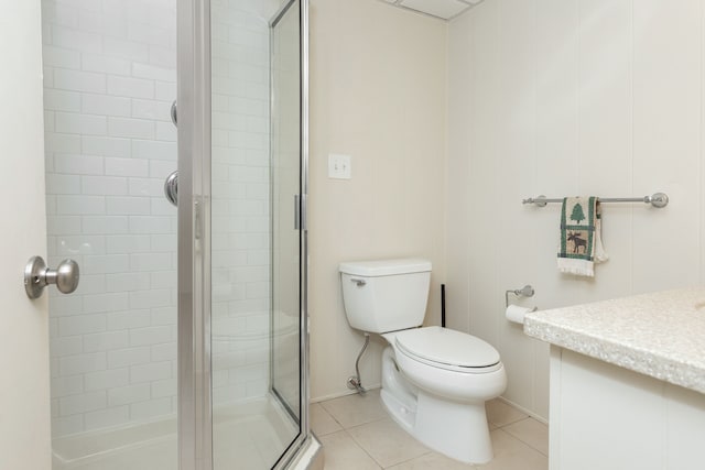 full bathroom featuring a shower stall, toilet, vanity, and tile patterned floors