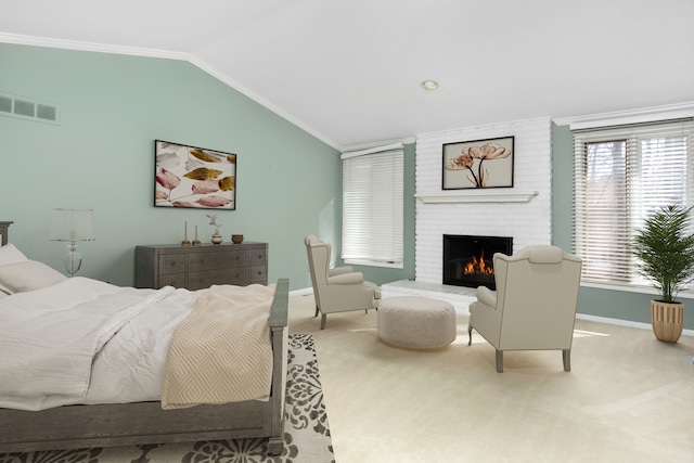 carpeted bedroom featuring vaulted ceiling, baseboards, ornamental molding, a brick fireplace, and visible vents