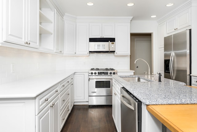 kitchen featuring white cabinets, appliances with stainless steel finishes, dark wood-style floors, and a sink