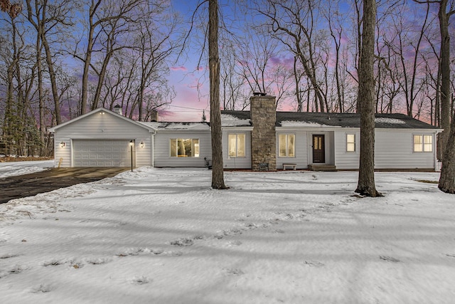 view of front of property featuring a garage and a chimney