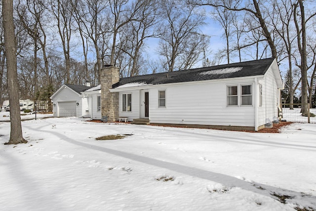 ranch-style house featuring a garage and a chimney