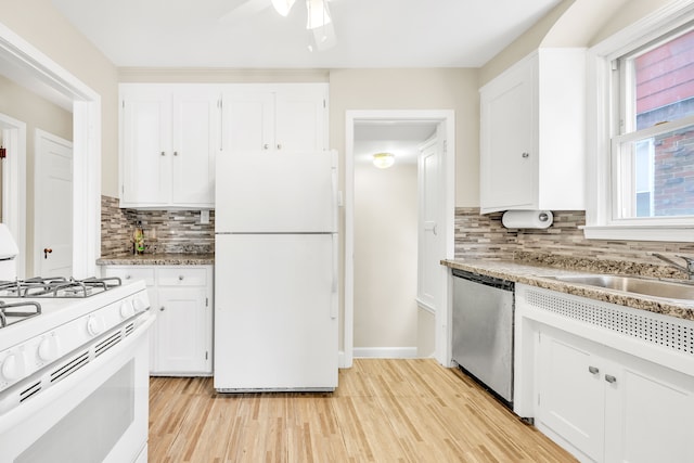 kitchen featuring decorative backsplash, white cabinetry, a sink, light wood-type flooring, and white appliances