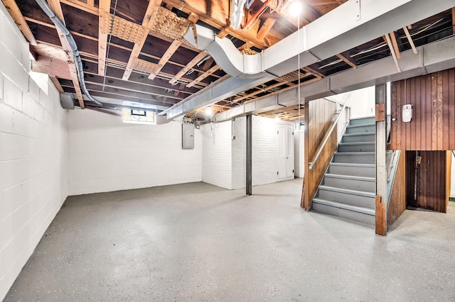 basement with electric panel and stairs