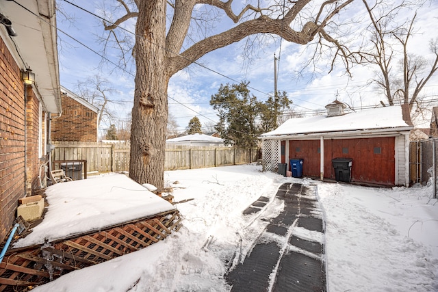 yard covered in snow with a fenced backyard