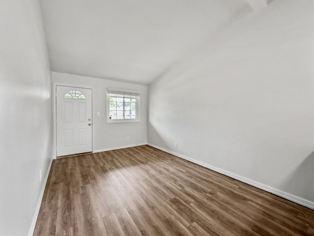 entryway with baseboards, vaulted ceiling, and wood finished floors