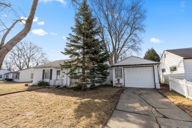 ranch-style house featuring a detached garage, an outbuilding, concrete driveway, and fence