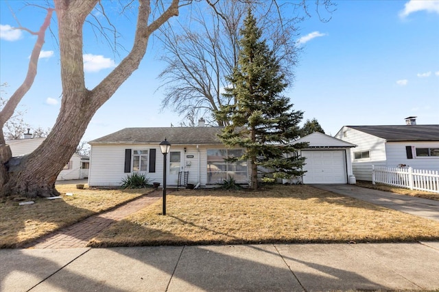 ranch-style home featuring concrete driveway and fence