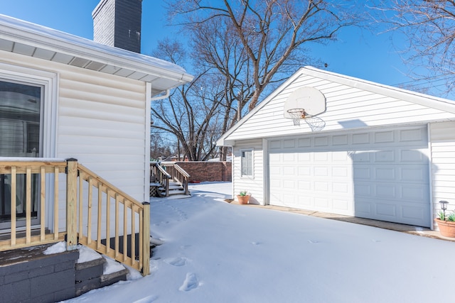 snow covered garage with a garage