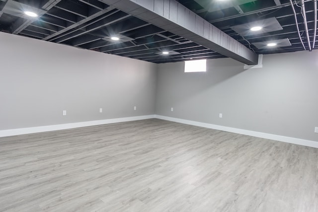 below grade area with wood finished floors and baseboards