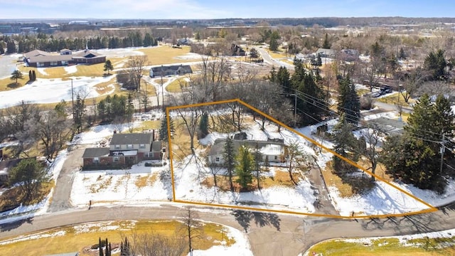 snowy aerial view featuring a residential view