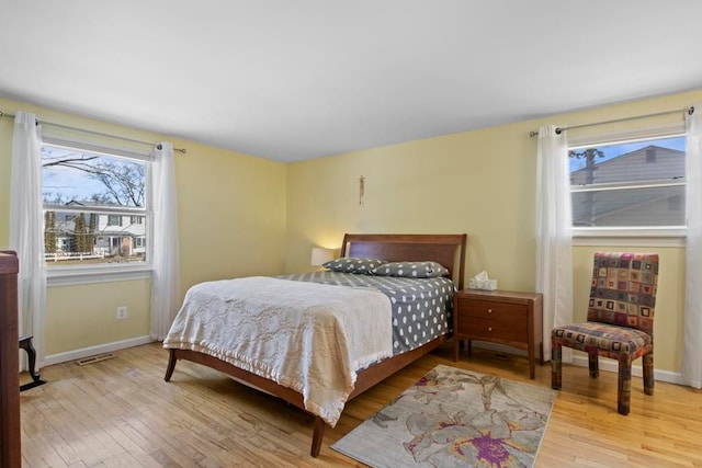 bedroom featuring baseboards and light wood-style floors