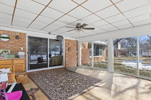 sunroom / solarium featuring a ceiling fan and a paneled ceiling