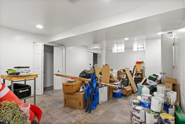 basement with stone finish flooring and recessed lighting