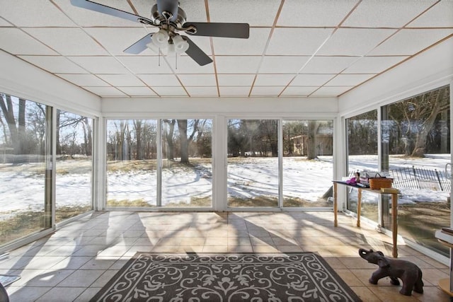 sunroom with a healthy amount of sunlight, ceiling fan, and a drop ceiling